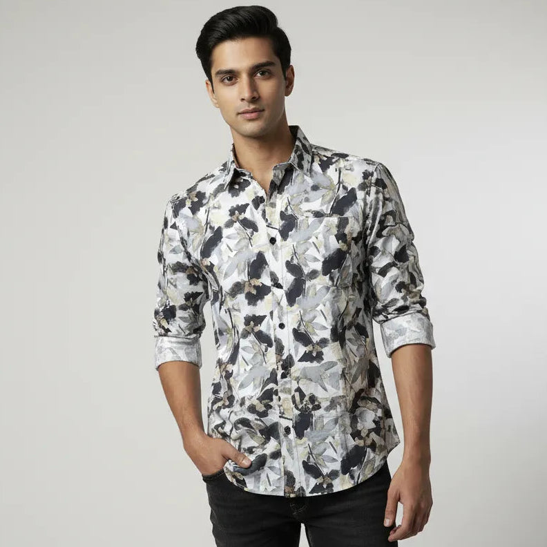 Man wearing a patterned shirt against a plain background